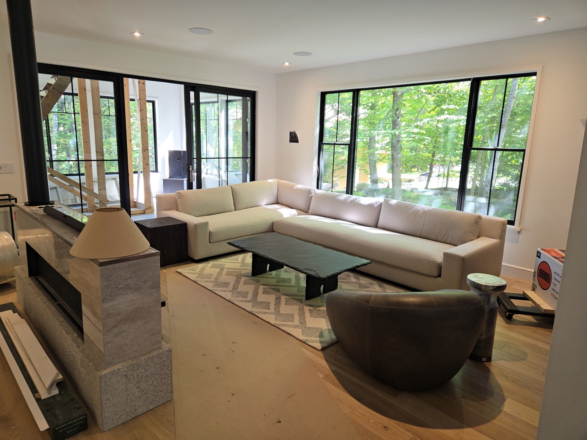Fernwood modern living room with large windows and low upholstered sofa