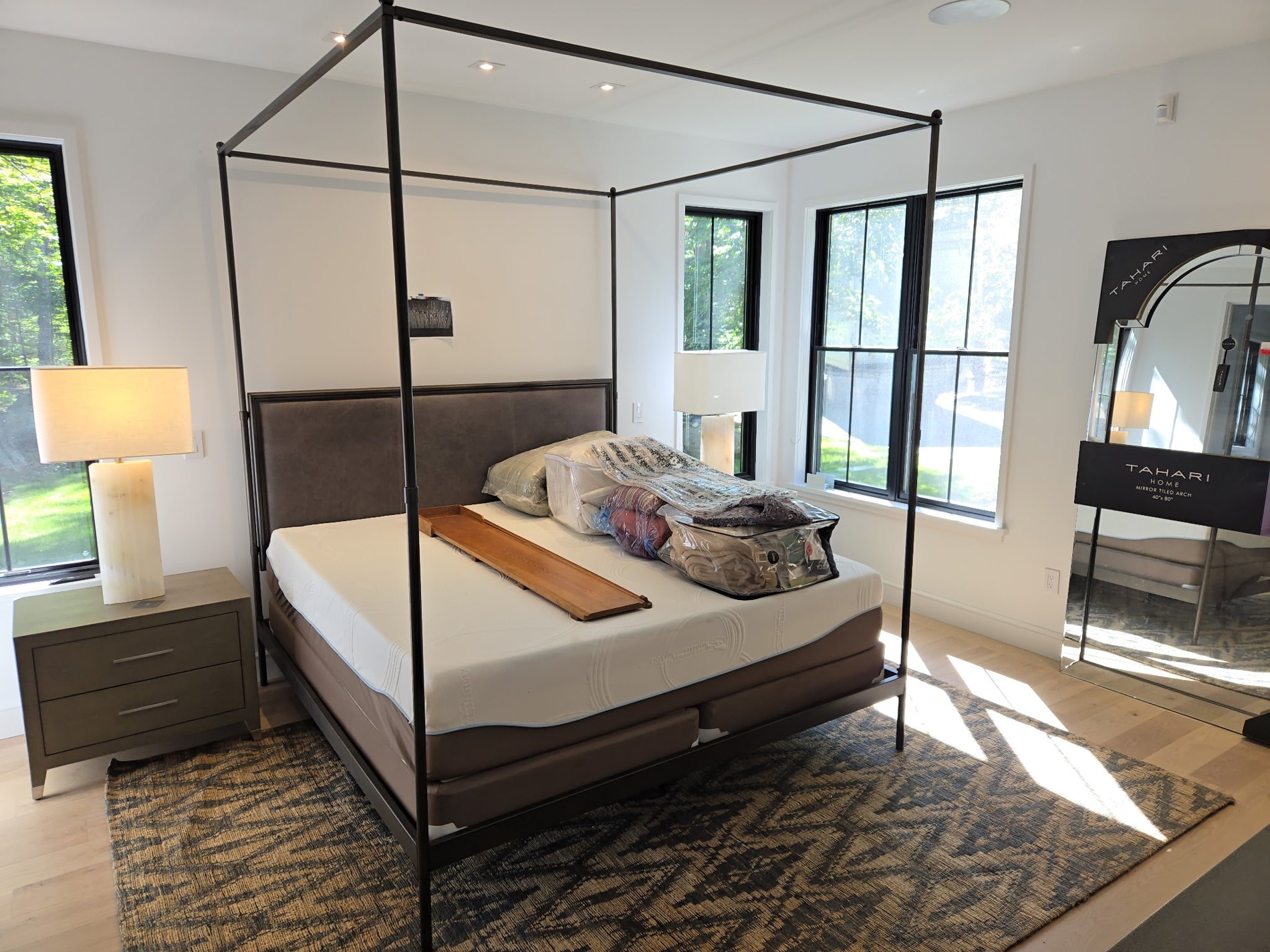 Fernwood bedroom with canopy bed and expansive glazing