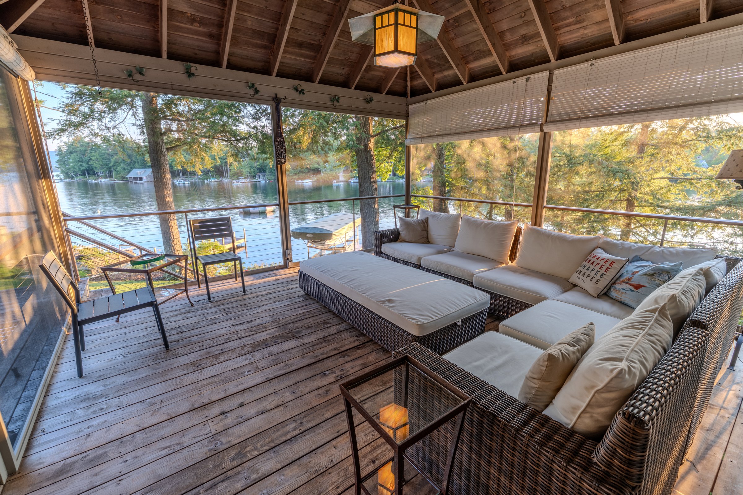 Screened porch with a large cushioned sectional overlooking Jobs Creek