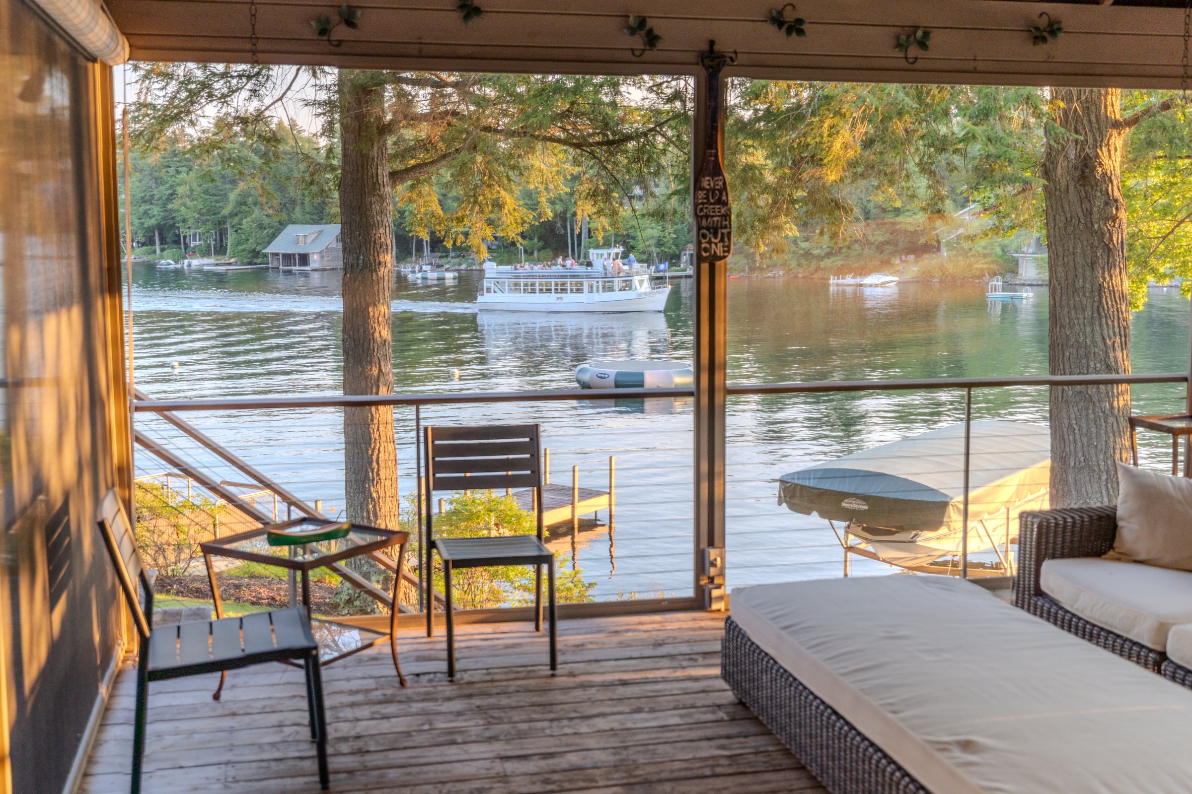 A passing boat seen from Woodland’s screened porch